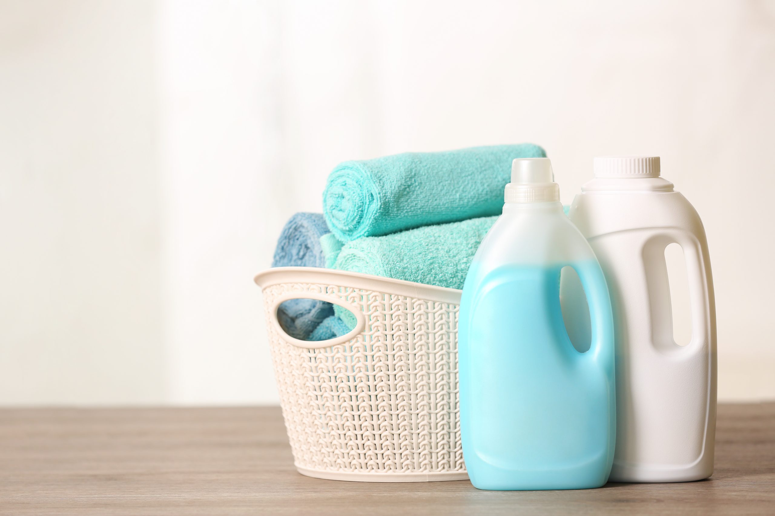 Basket,With,Clean,Towels,And,Detergents,On,Table.,Space,For